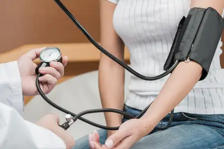 woman-getting her-blood-pressure-checked-by-a doctor